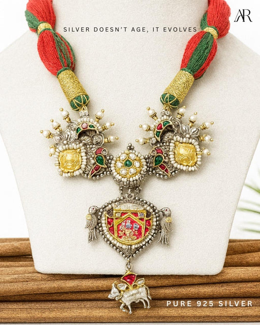 Sterling silver Heritage Crest pendant necklace with enamel detailing, parrots, symbolic motifs, and red-green woven cord – AplusR Jewelry